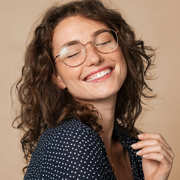woman with glasses smiling